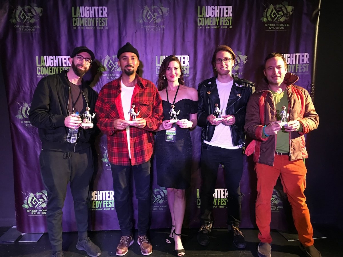 LA Comedy Fest winners holding awards at the Greenhouse Studios ceremony in Los Angeles