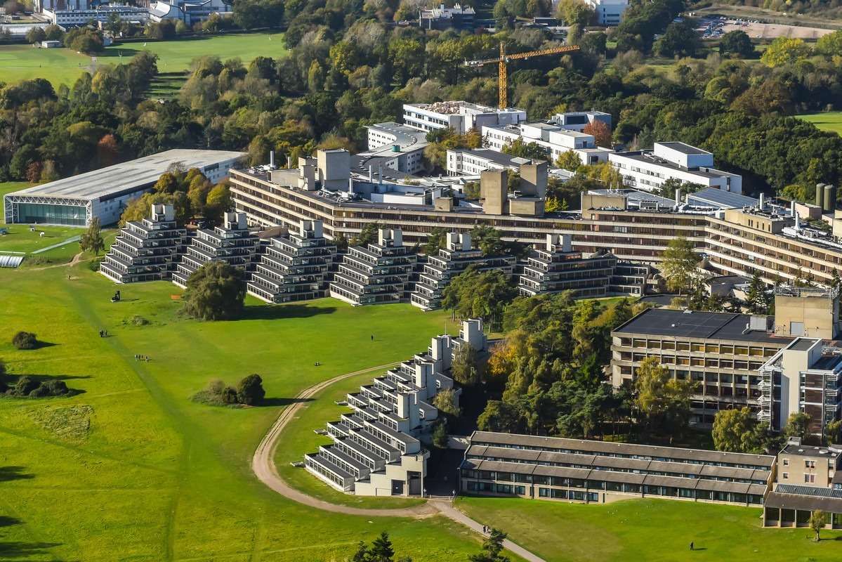 Aerial view of brutalist university campus with terraced concrete buildings in Norfolk