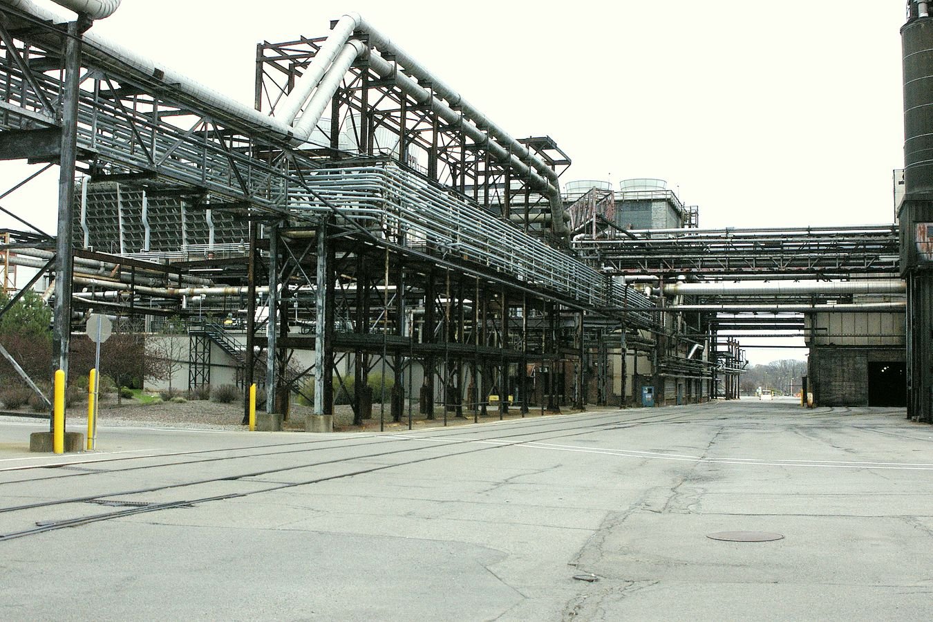 Decommissioned industrial facility with elevated pipework and conveyors in upstate New York