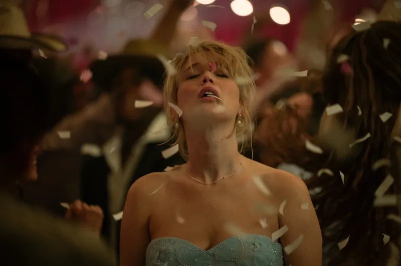 film still showing Jennifer Lawrence lifting her head into falling confetti