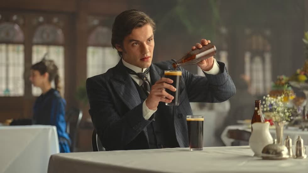 Film still from House of Guinness showing a character pouring a pint of guinness