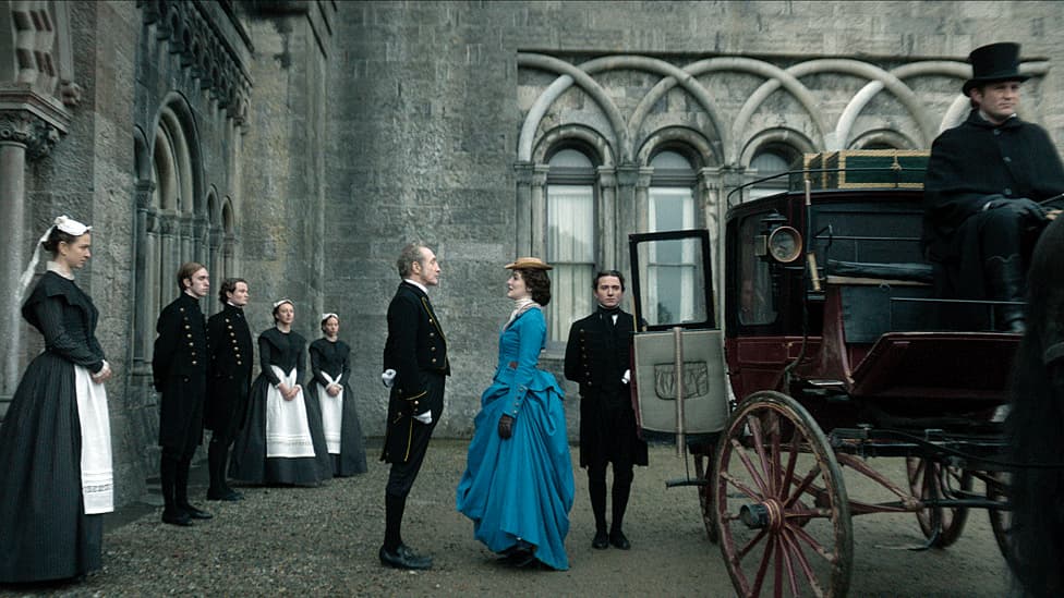 Film still from House of Guiness showing characters stood outside a stately home