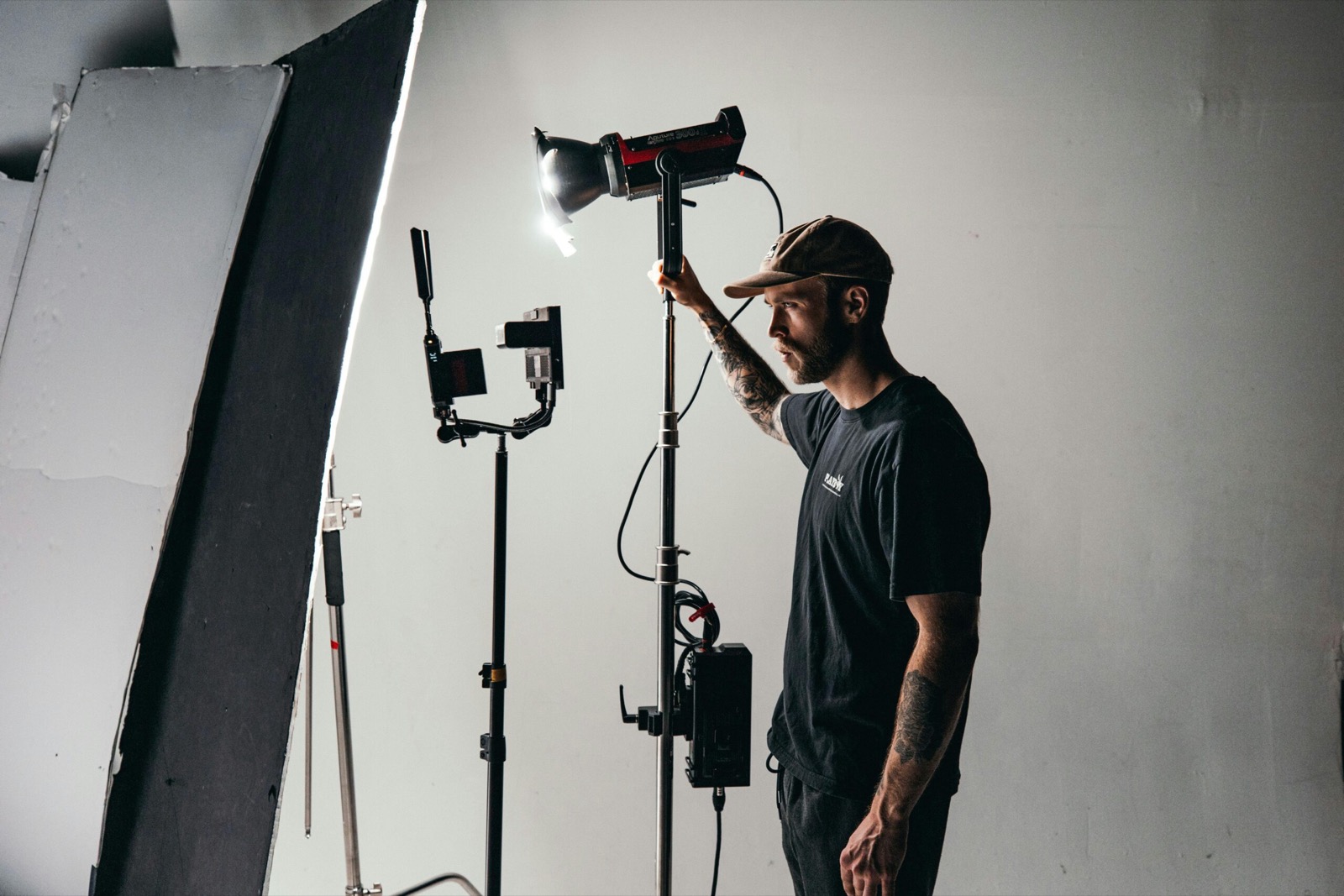 image of a film crew member adjusting the lighting set up on a film set