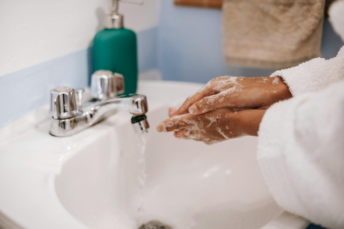 image of person washing hands in a sink